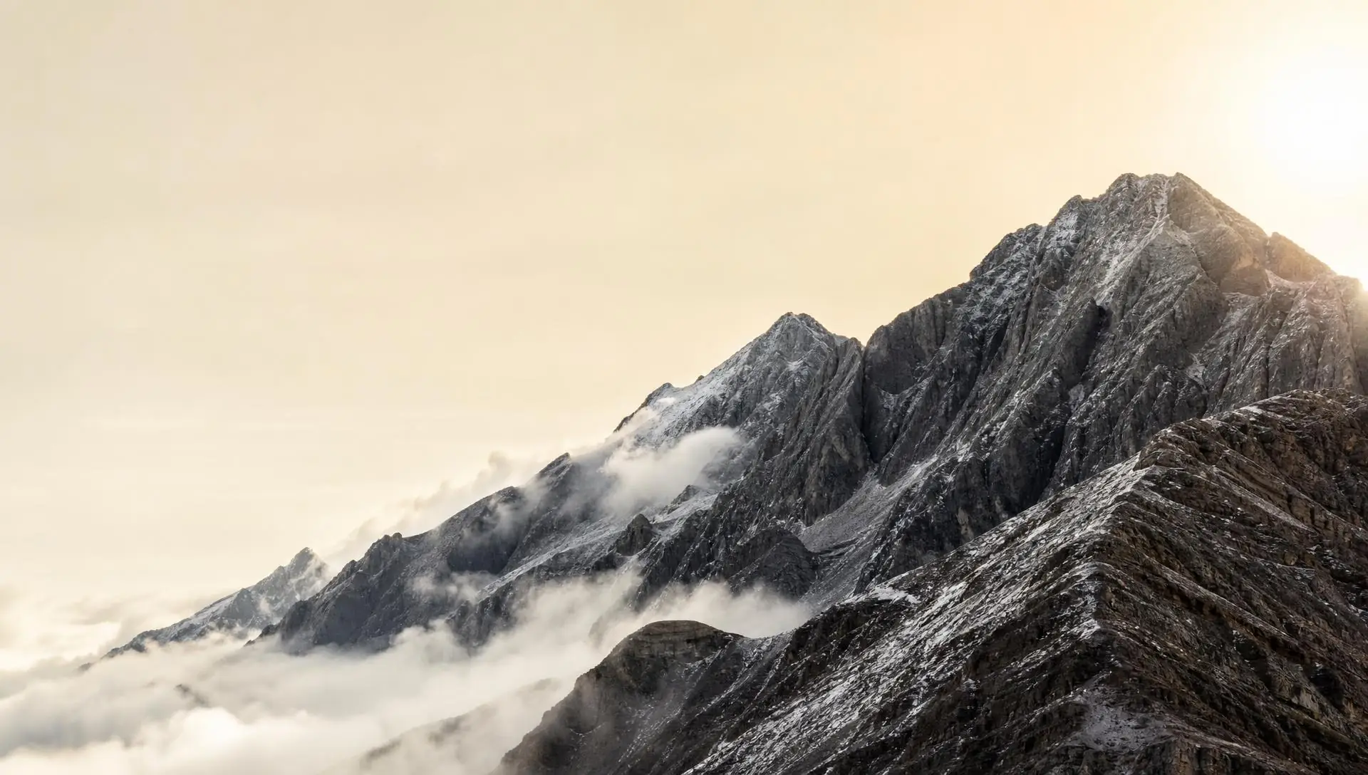 Mountain ridge above a sea of clouds at sunrise